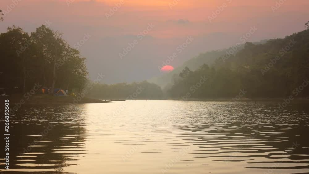 4K. landscape of river view during the sunrise time with many colorful camping tent at campsite 4K. landscape of river view during the sunrise time with many colorful camping tent at campsite