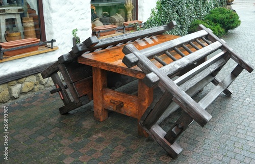 Wooden table and benches in the yard after a rain  background