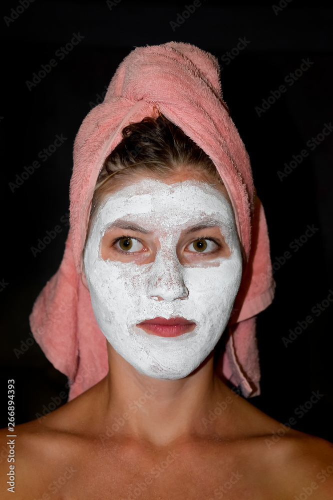 Cosmetic white face mask of toothpaste. Woman in white cosmetic mask Cosmetic white face mask of toothpaste. Woman in white cosmetic mask