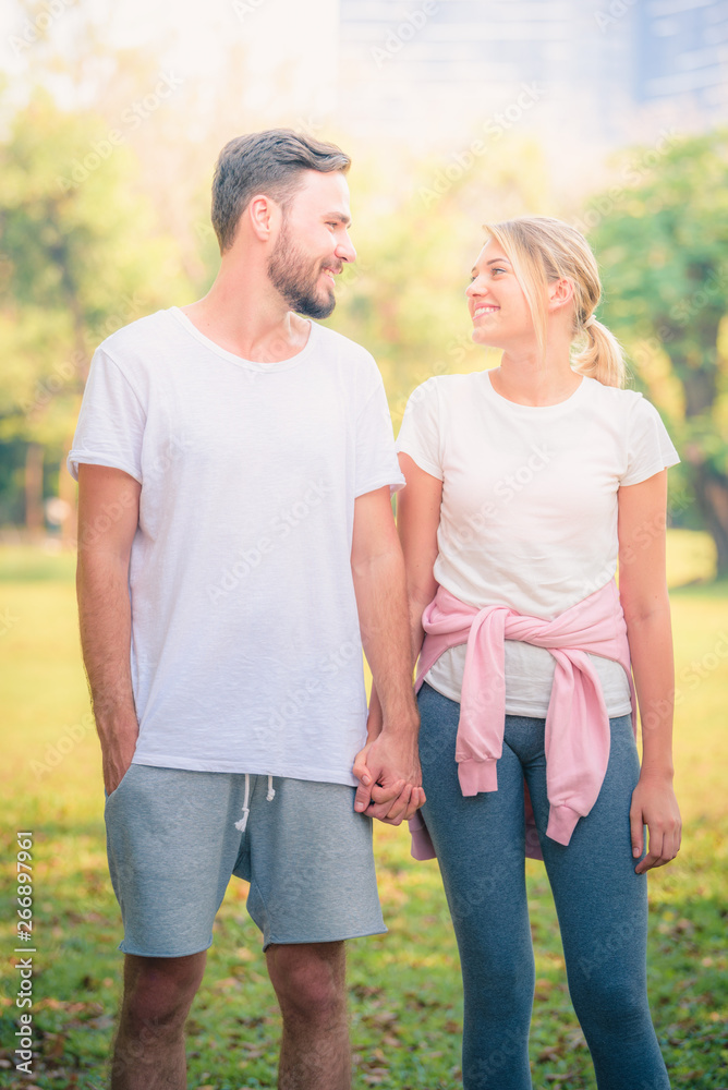 Portrait image of Young couple enjoying in the park at sunset. Concept romantic and love. Warm tone. Portrait image of Young couple enjoying in the park at sunset. Concept romantic and love. Warm tone.