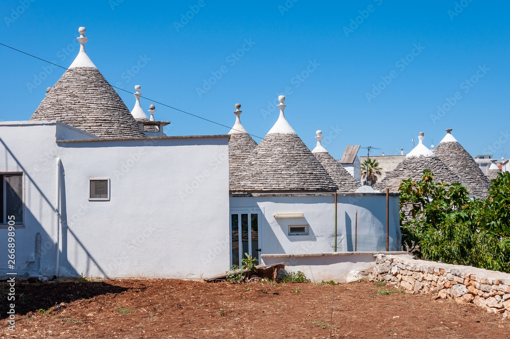 Alberobello, Italy. The picturesque village of trulli. Stone houses built in the typical circular shape with cone roofs.