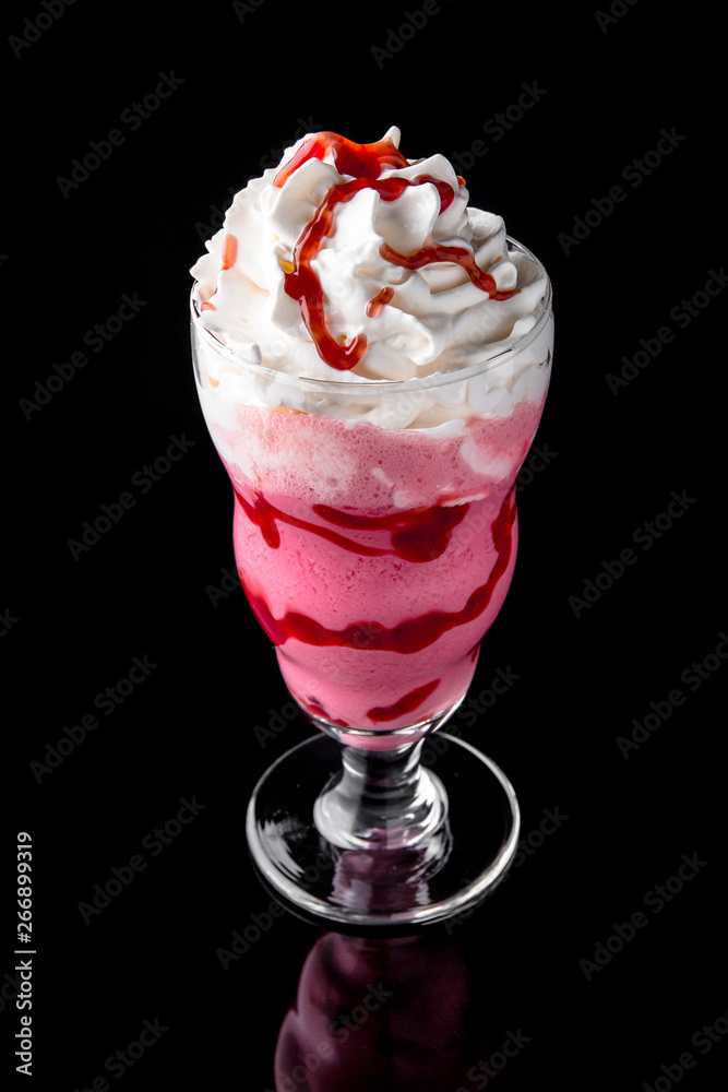 Milkshake. A cool drink of milk, ice cream, chocolate, vanilla, strawberries, on a black background with stones and ice. Cocktail card for a bar or restaurant iisolated on black Milkshake. A cool drink of milk, ice cream, chocolate, vanilla, strawberries, on a black background with stones and ice. Cocktail card for a bar or restaurant iisolated on black