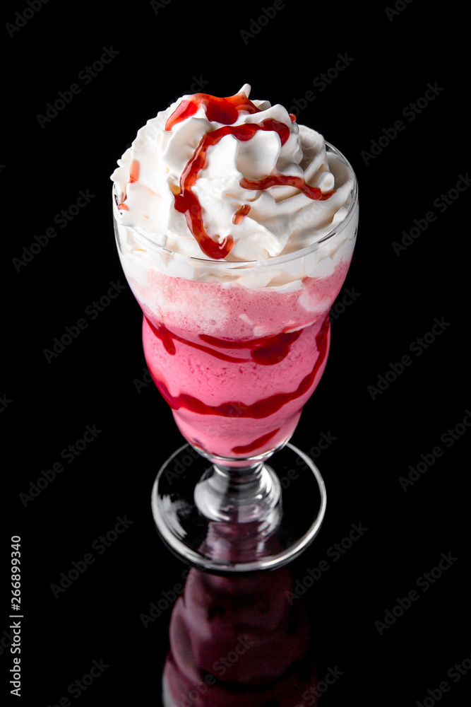 Milkshake. A cool drink of milk, ice cream, chocolate, vanilla, strawberries, on a black background with stones and ice. Cocktail card for a bar or restaurant iisolated on black Milkshake. A cool drink of milk, ice cream, chocolate, vanilla, strawberries, on a black background with stones and ice. Cocktail card for a bar or restaurant iisolated on black