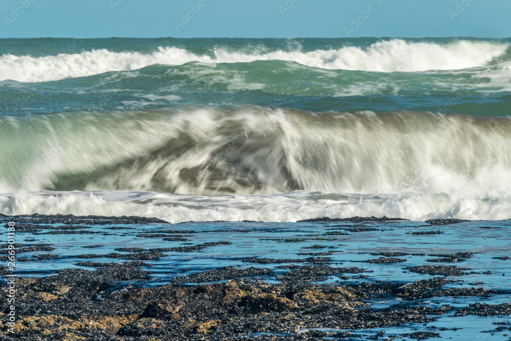 Sea waves hitting on the stones near the coast. White foam comes out of the waves white foam of a sea wave Sea waves hitting on the stones near the coast. White foam comes out of the waves white foam of a sea wave