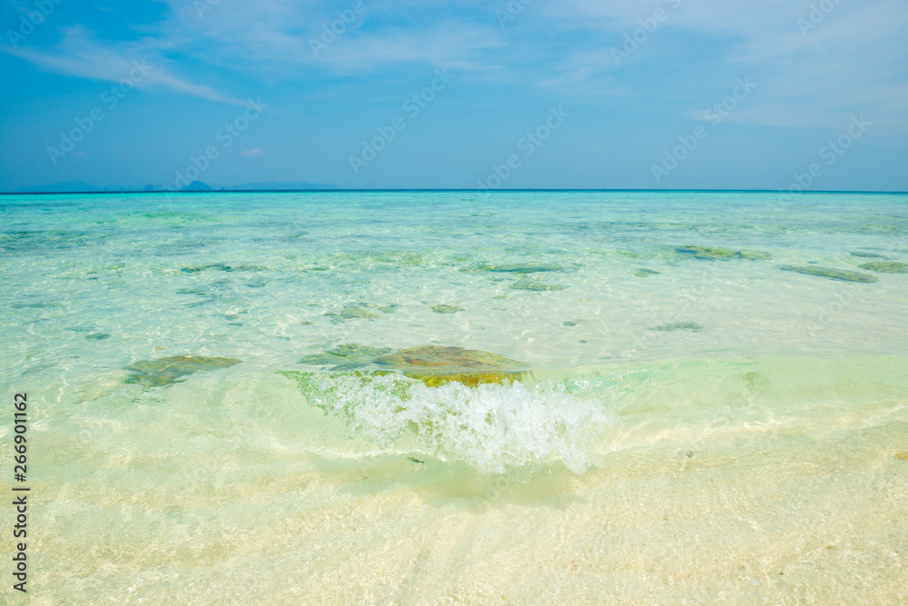 Seascape of tropical sea with clear transparent turquois water, corals, stones and blue sky. Can be used as summer vacation background
