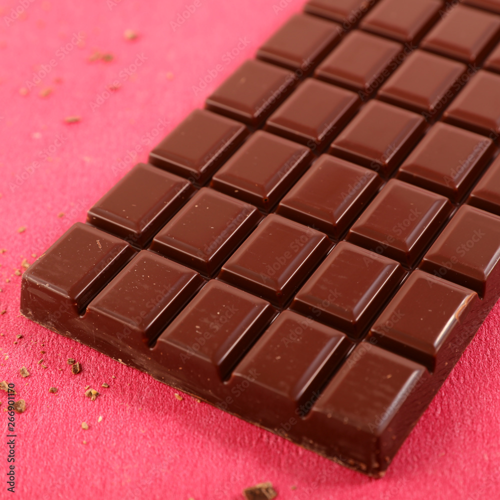 Fototapeta premium chocolate bar on red background