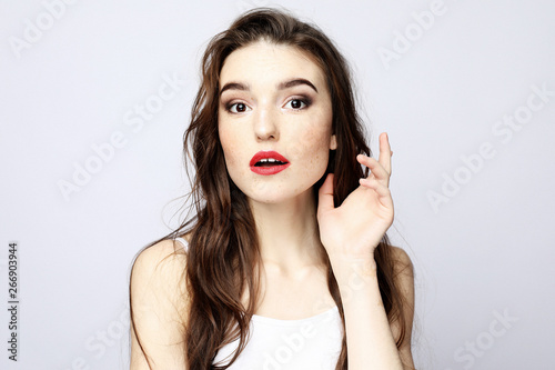 lifestyle, beauty and people concept: Young cute smiling girl over white background