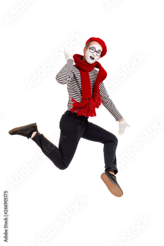 Full length portrait of mime woman artist jumping isolated on white background