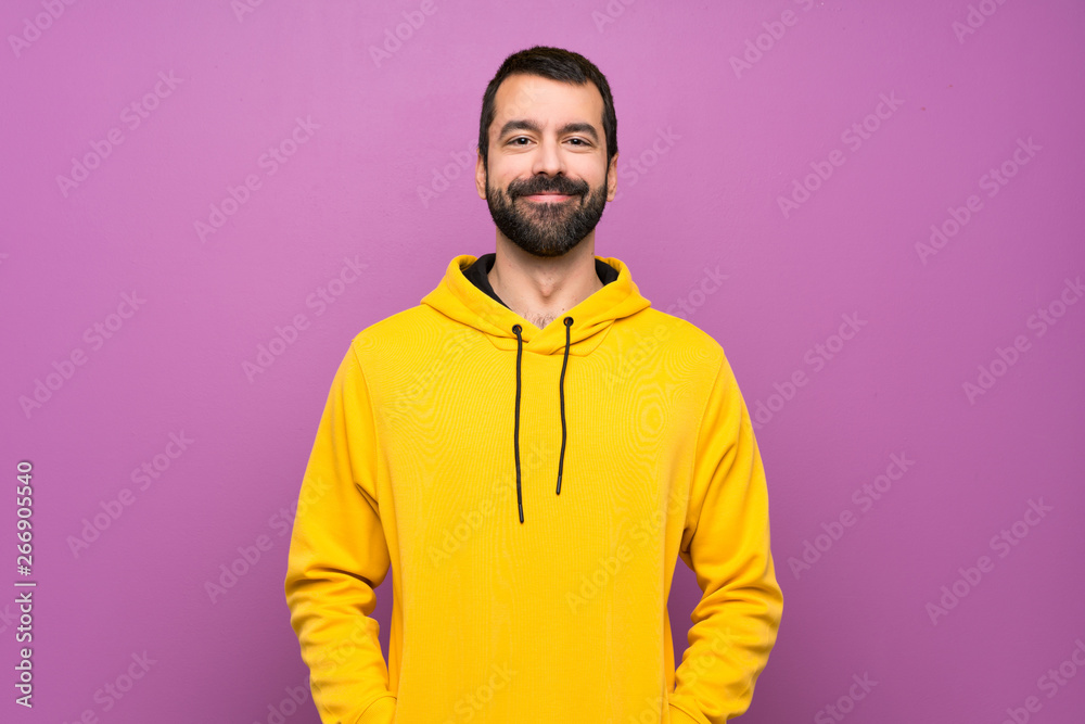 Handsome man with yellow sweatshirt laughing Handsome man with yellow sweatshirt laughing