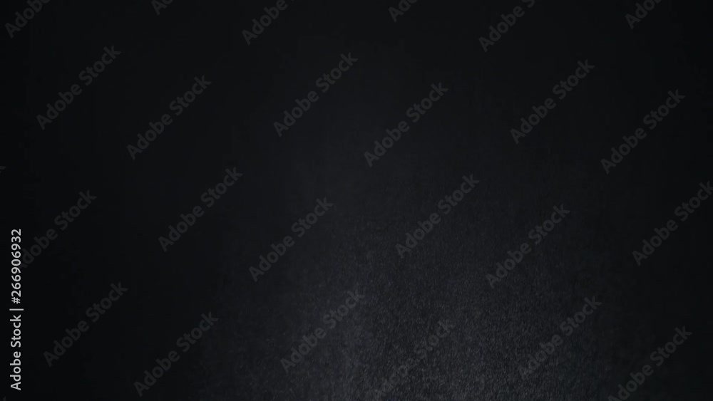 White exploding powder over black background