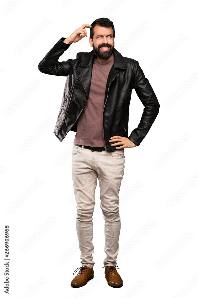 Handsome man with beard having doubts while scratching head over isolated white background Handsome man with beard having doubts while scratching head over isolated white background