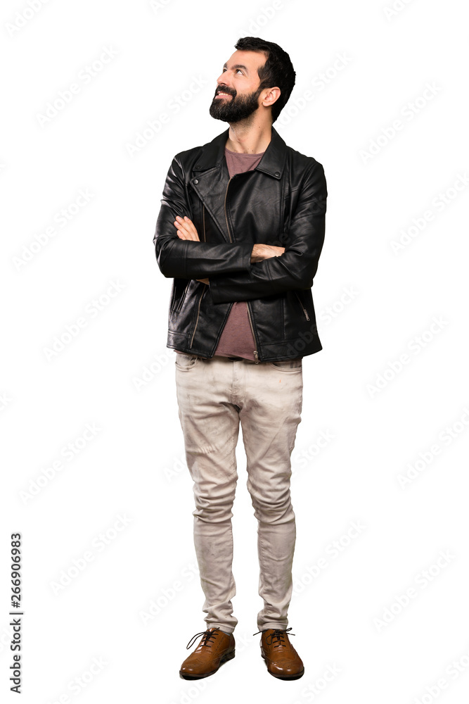 Handsome man with beard looking up while smiling over isolated white background Handsome man with beard looking up while smiling over isolated white background