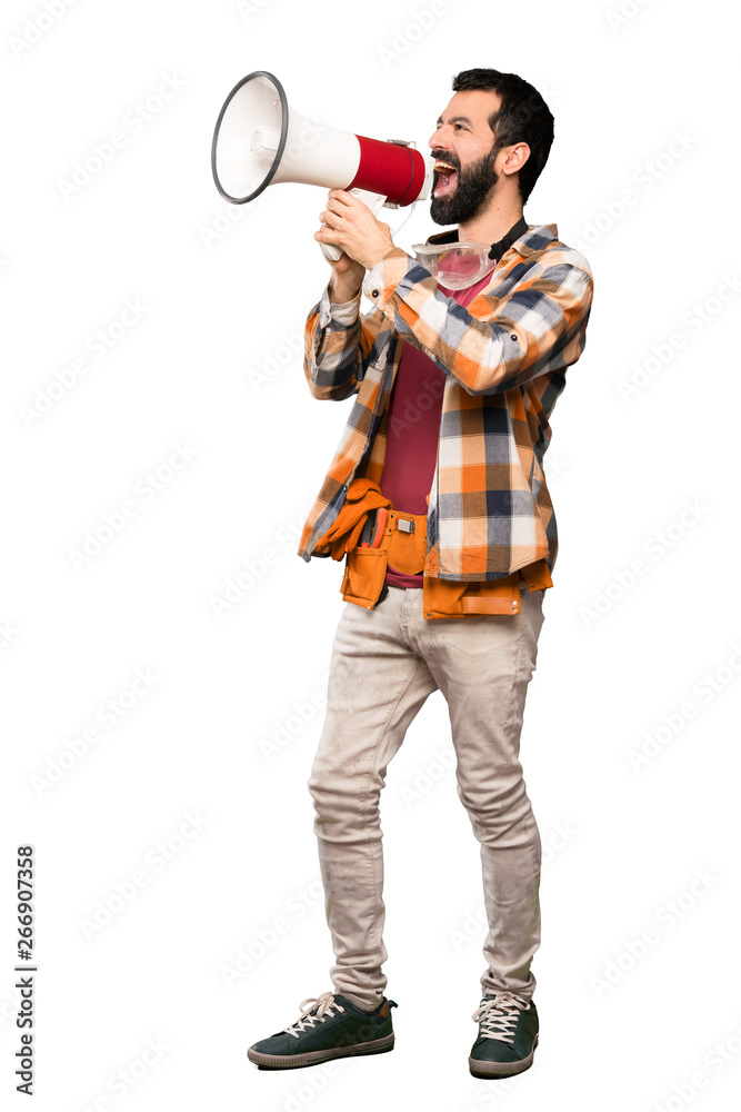 Craftsmen man shouting through a megaphone over isolated white background Craftsmen man shouting through a megaphone over isolated white background