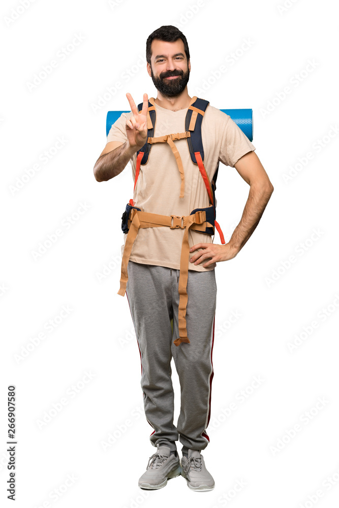Hiker man smiling and showing victory sign over isolated white background Hiker man smiling and showing victory sign over isolated white background
