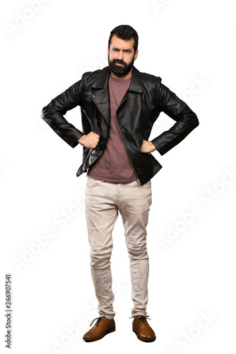 Handsome man with beard angry over isolated white background