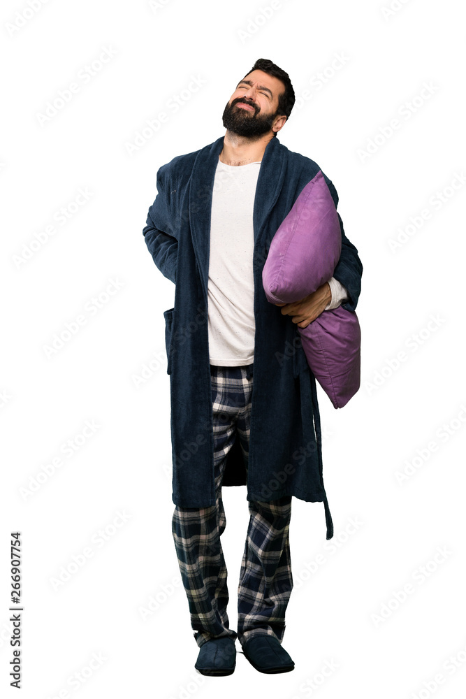 Man with beard in pajamas suffering from backache for having made an effort over isolated white background