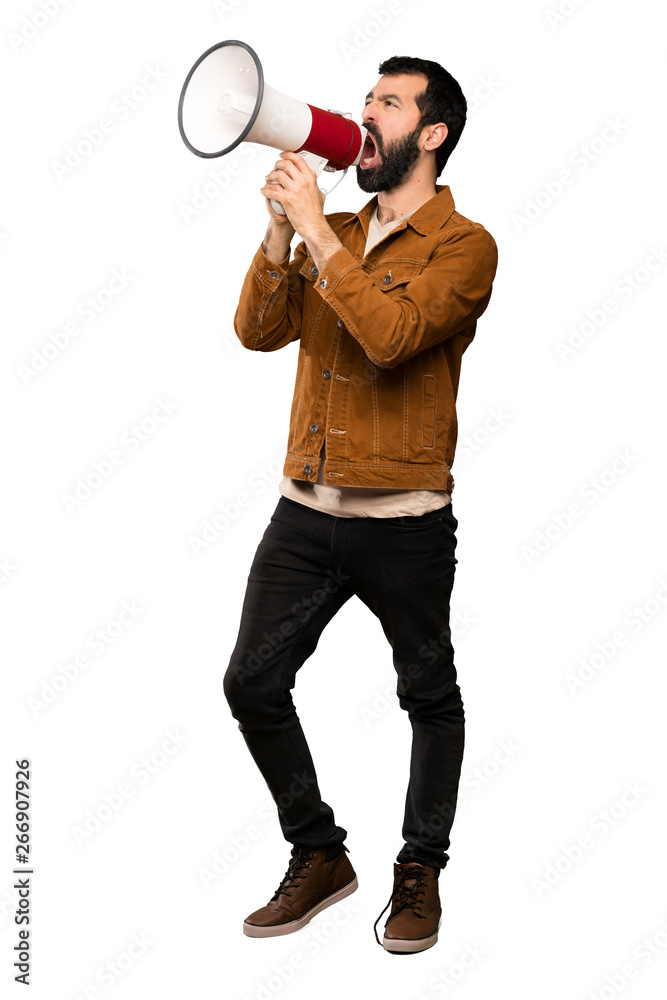 Handsome man with beard shouting through a megaphone over isolated white background Handsome man with beard shouting through a megaphone over isolated white background