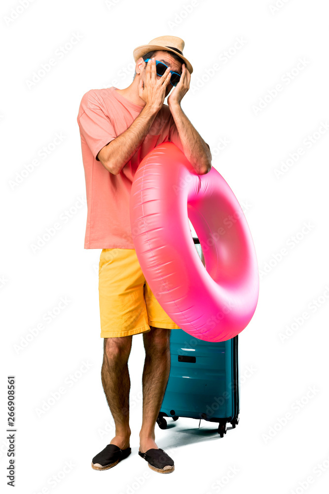 A full-length shot of Man with hat and sunglasses on his summer A full-length shot of Man with hat and sunglasses on his summer