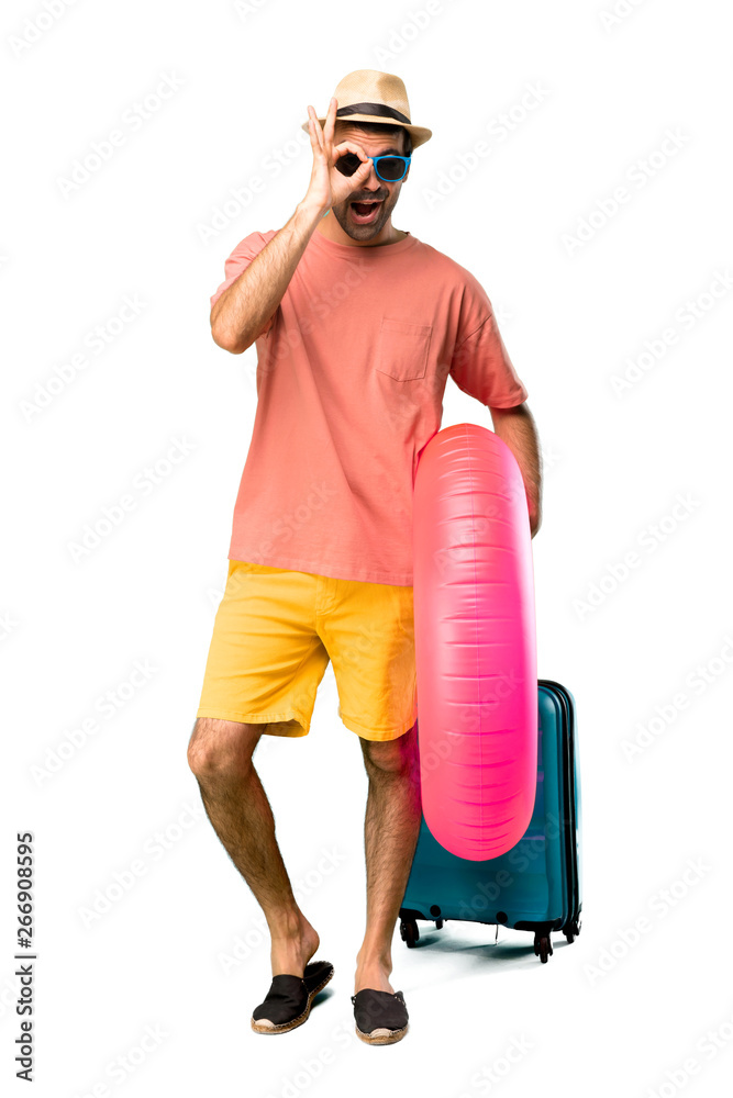 A full-length shot of Man with hat and sunglasses on his summer A full-length shot of Man with hat and sunglasses on his summer
