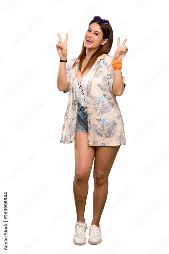 Full-length shot of Young woman in bikini in summer holidays showing victory sign with both hands over isolated white background Full-length shot of Young woman in bikini in summer holidays showing victory sign with both hands over isolated white background