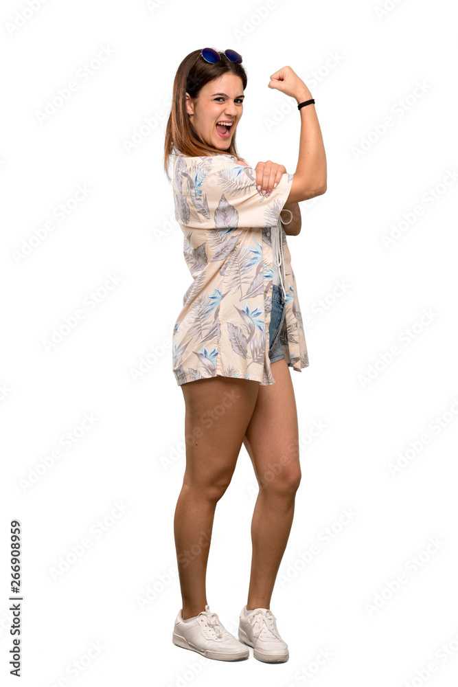 Full-length shot of Young woman in bikini in summer holidays doing strong gesture over isolated white background Full-length shot of Young woman in bikini in summer holidays doing strong gesture over isolated white background