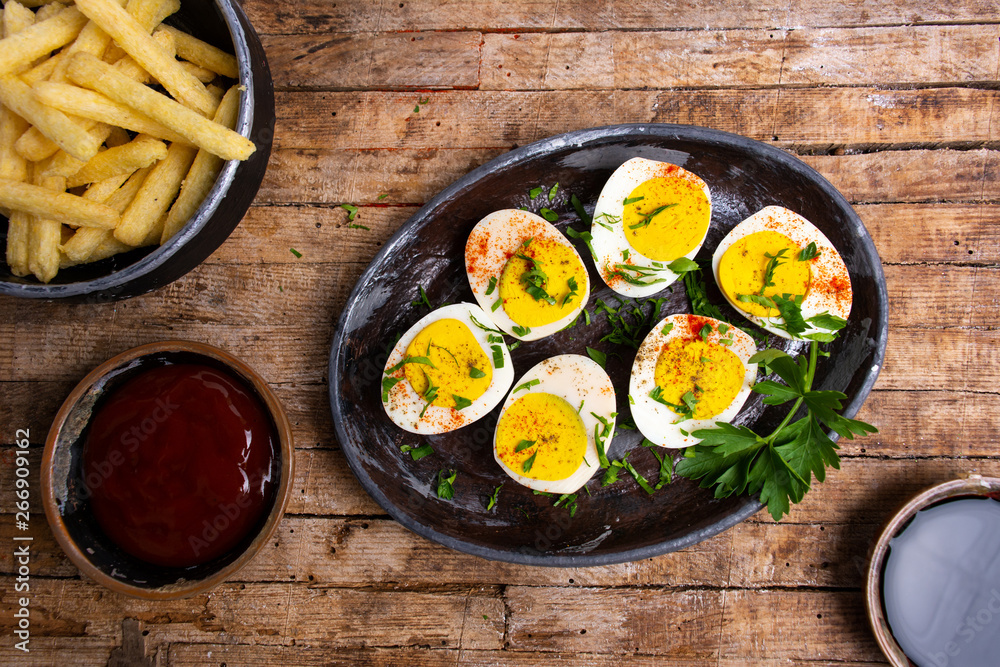 Boiled eggs and french fires on a table Boiled eggs and french fires on a table