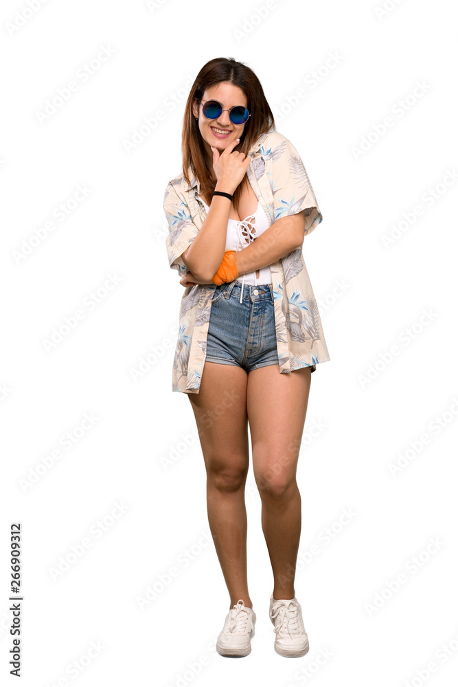 Full-length shot of Young woman in bikini in summer holidays with glasses and smiling over isolated white background Full-length shot of Young woman in bikini in summer holidays with glasses and smiling over isolated white background