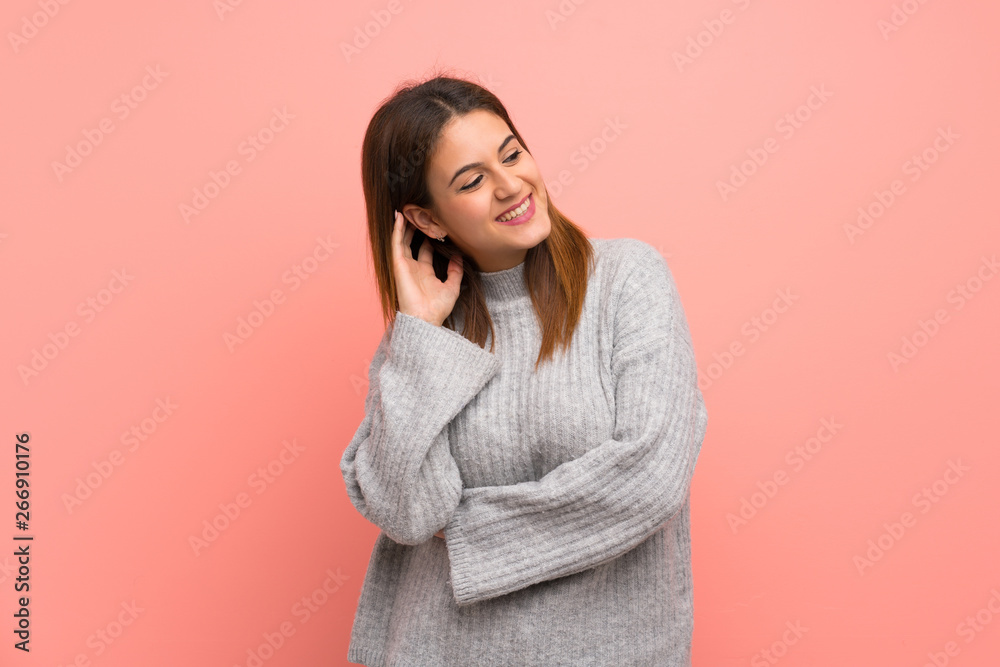 Young woman over pink wall thinking an idea Young woman over pink wall thinking an idea