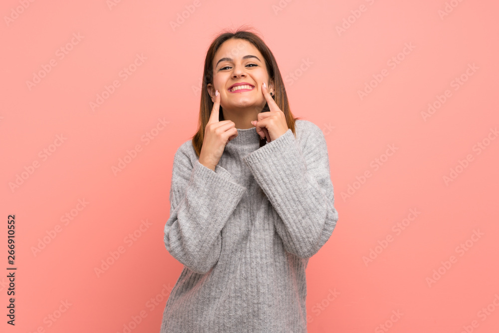 Young woman over pink wall smiling with a happy and pleasant expression Young woman over pink wall smiling with a happy and pleasant expression