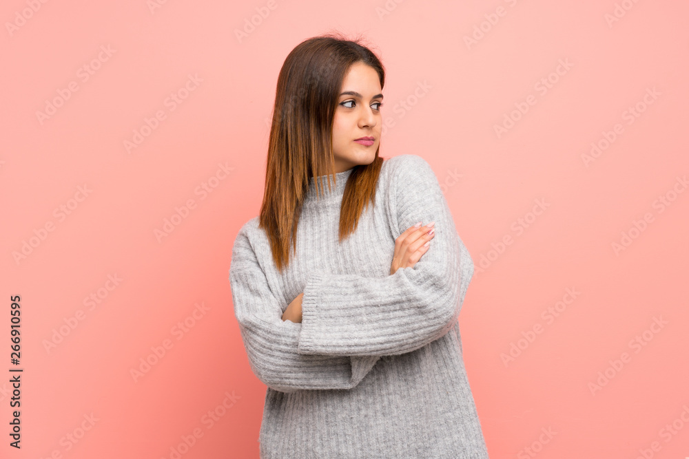 Young woman over pink wall portrait Young woman over pink wall portrait