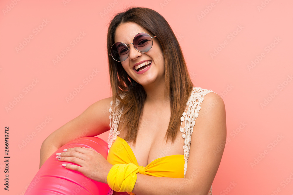 Young woman in bikini in summer holidays laughing