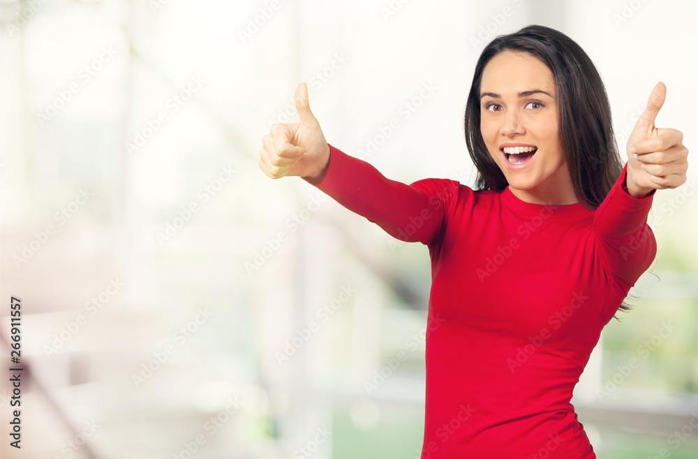 Close up portrait of a beautiful girl looking at camera and showing thumbs up on a white background Close up portrait of a beautiful girl looking at camera and showing thumbs up on a white background