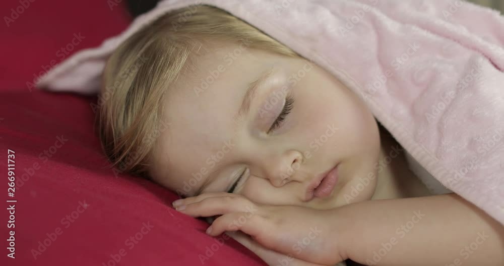 Cute baby sleeping on the bed at home. Little girl sleeping in morning light Cute baby sleeping on the bed at home. Little girl sleeping in morning light