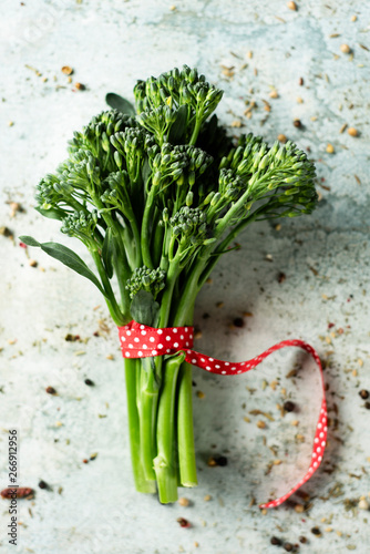 bunch of broccolini on a stone surface photo