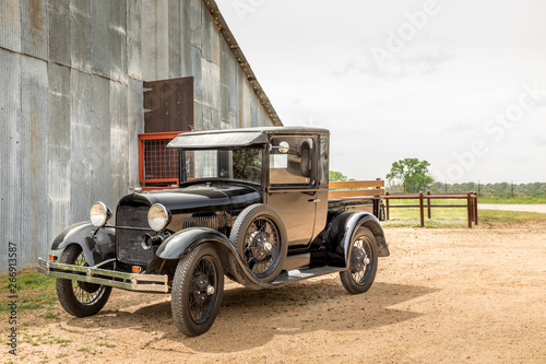 Old vintage car before a barn