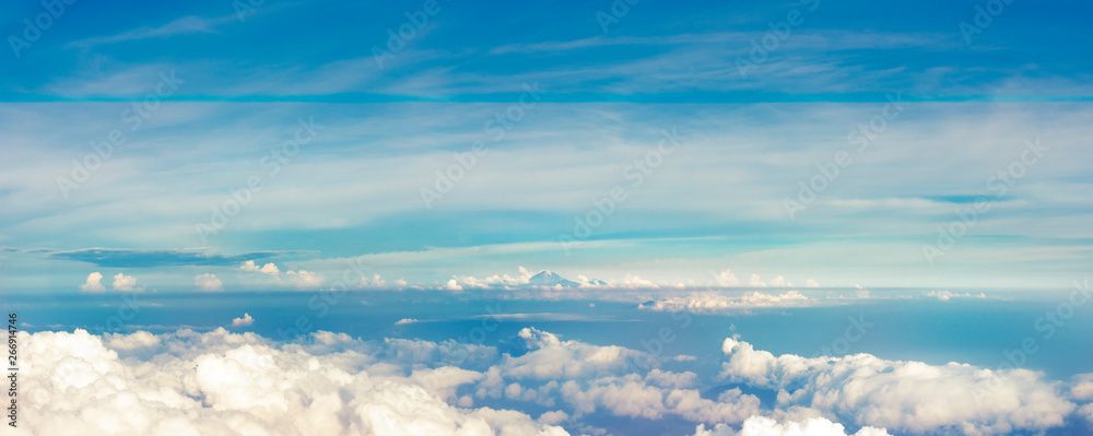 Panoramic view from a height above the clouds. Panoramic view of the horizon with volcano Rinjani afar.