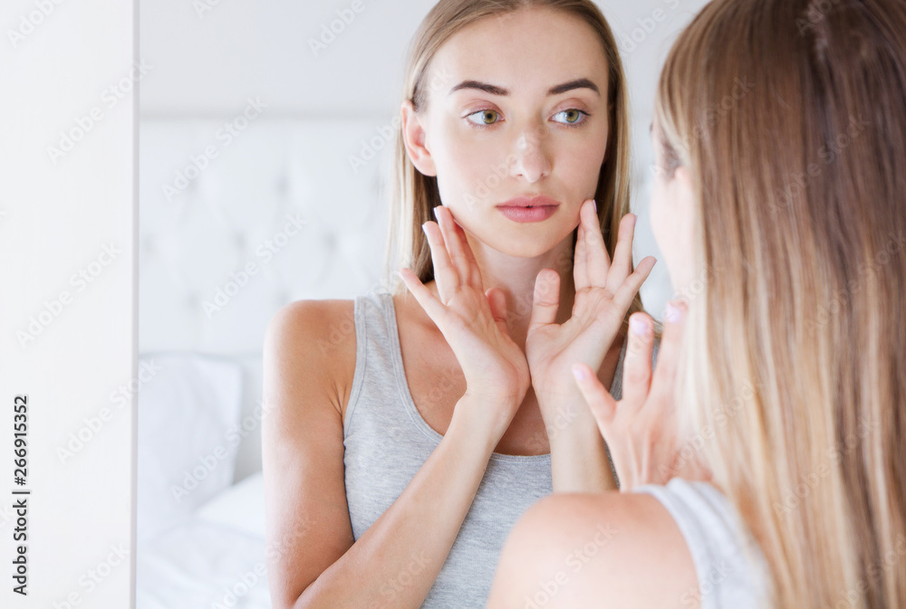The beautiful young girl with a clean fresh skin touches with a hand a cheek - beauty, hygiene, morning and people concept. The beautiful young girl with a clean fresh skin touches with a hand a cheek - beauty, hygiene, morning and people concept.