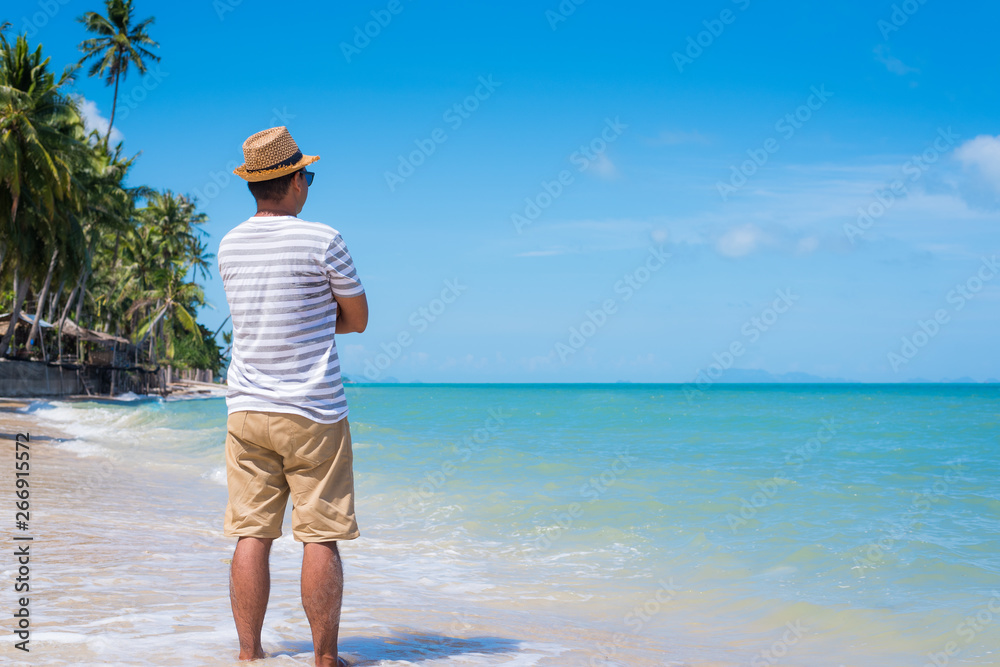Happy young asian man on beach in vacation time.