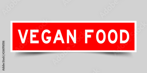 Square red sticker label in word vegan food on gray background