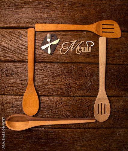 Restaurant menu. Top view of woodboard menu laying on the rustic wooden desk with accessories. photo