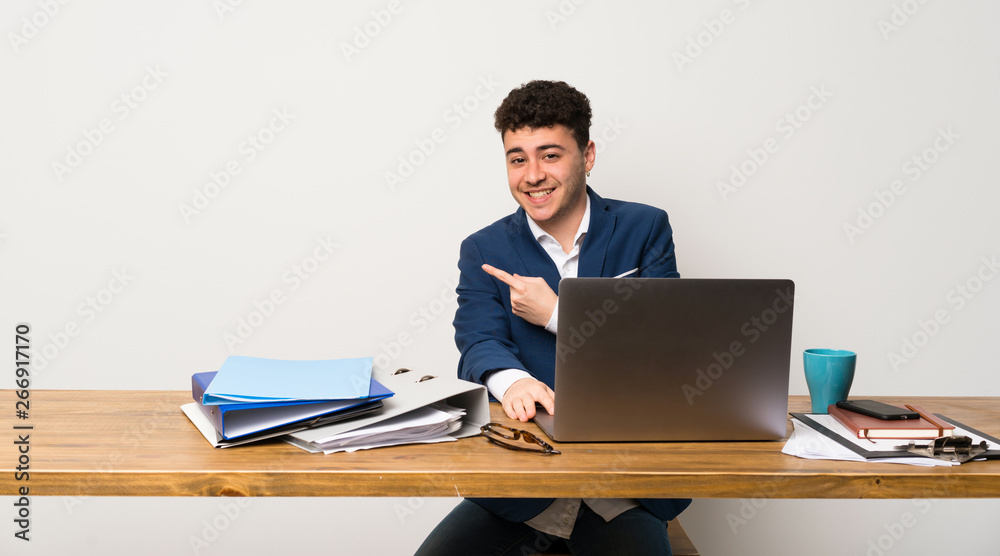 Business man in a office pointing to the side to present a product Business man in a office pointing to the side to present a product