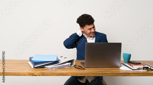Business man in a office with neckache