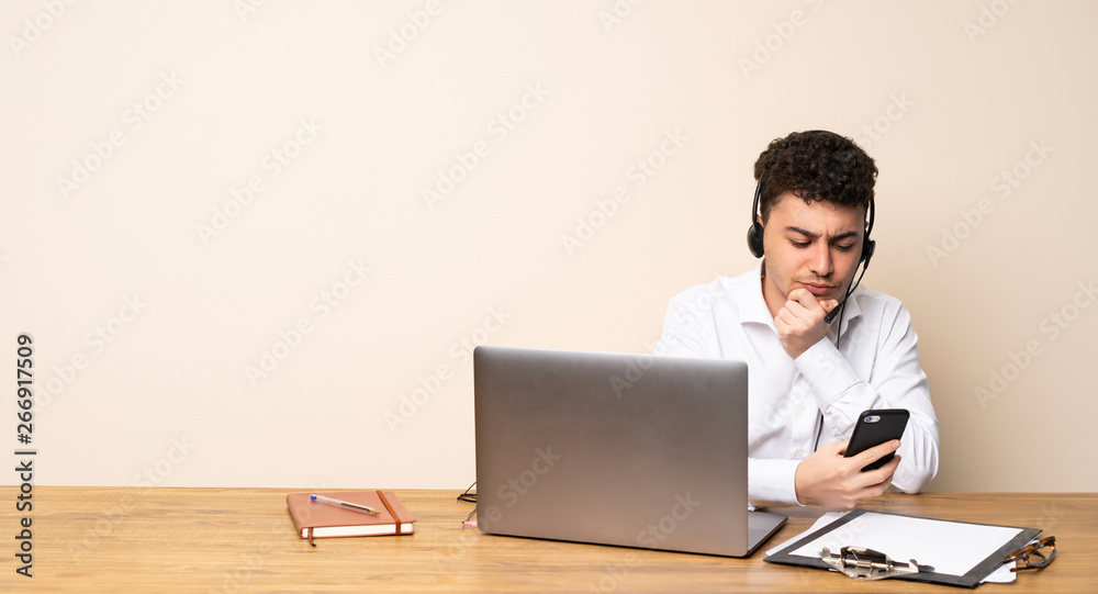 Telemarketer man thinking and sending a message Telemarketer man thinking and sending a message