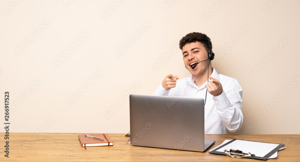 Telemarketer man pointing to the front and smiling Telemarketer man pointing to the front and smiling