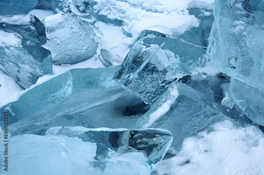 Sun rays are refracted by the transparent ice of Lake Baikal. crystal clear ice fragments — hummocks Sun rays are refracted by the transparent ice of Lake Baikal. crystal clear ice fragments — hummocks