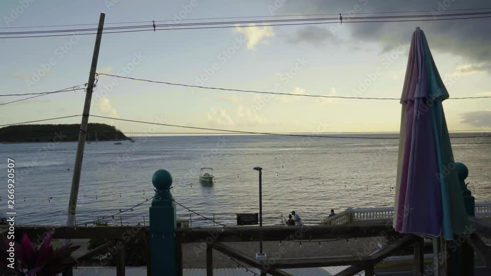 View of the bay of the small town of Esmeralda located in Vieques Puerto Rico during sunset and dusk with beautiful vivid colors among boats, islands, and coast. View of the bay of the small town of Esmeralda located in Vieques Puerto Rico during sunset and dusk with beautiful vivid colors among boats, islands, and coast.