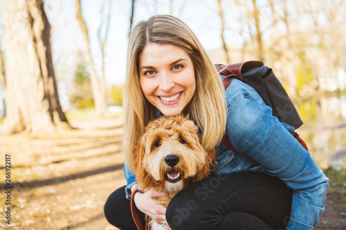 Canvas Print Happy Labradoodle Dog and woman outside at the park