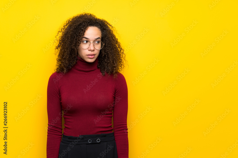 Dominican woman with turtleneck sweater is a little bit nervous and scared pressing the teeth Dominican woman with turtleneck sweater is a little bit nervous and scared pressing the teeth