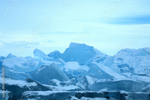 Sun rays are refracted by the transparent ice of Lake Baikal. crystal clear ice fragments — hummocks