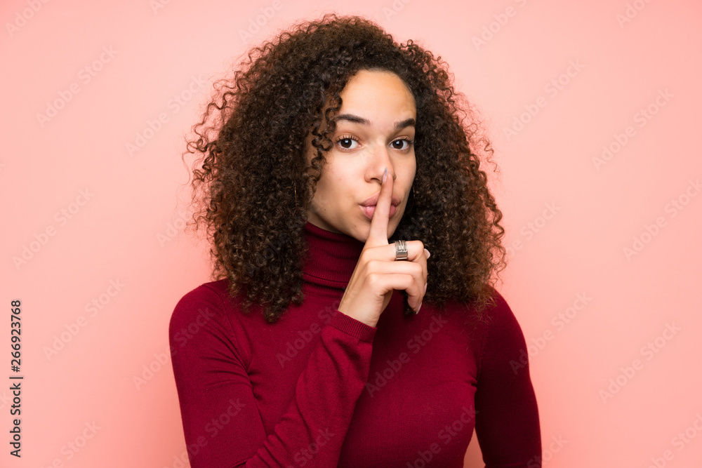Dominican woman with turtleneck sweater doing silence gesture Dominican woman with turtleneck sweater doing silence gesture